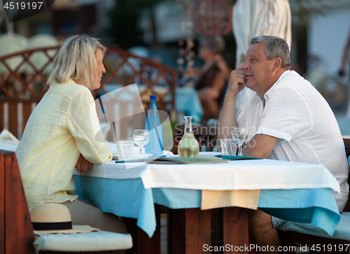 Image of Loving mature couple having dinner in outdoor cafe