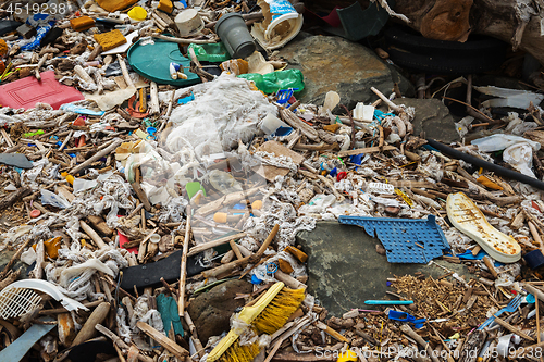 Image of Spilled garbage on the beach near the big city. Empty used dirty plastic bottles and other garbage. Environmental pollution. Ecological problem.