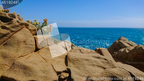 Image of Defocused. Beautiful azure sea and the rocky beach