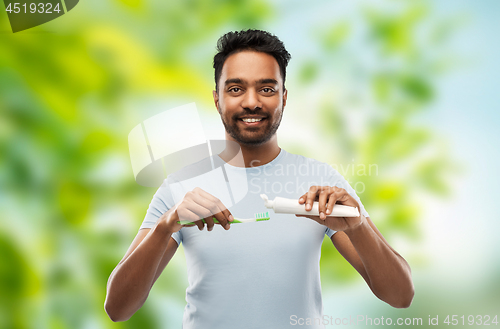 Image of indian man with toothbrush and toothpaste