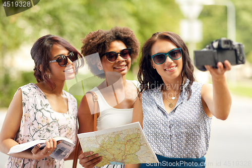 Image of women with map travelling and recording video blog