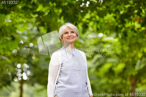 Image of happy senior woman at summer park