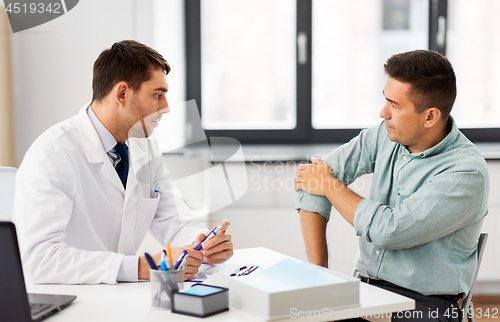 Image of patient showing sore arm to doctor at hospital