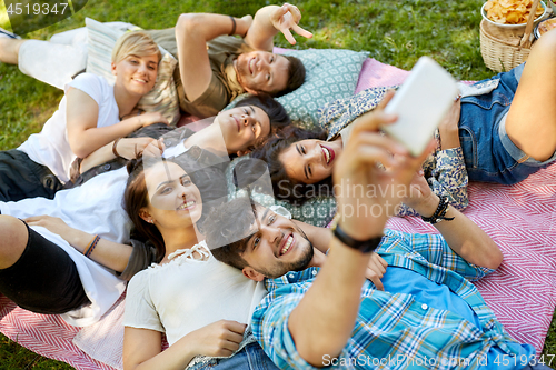 Image of friends taking selfie on picnic at summer park