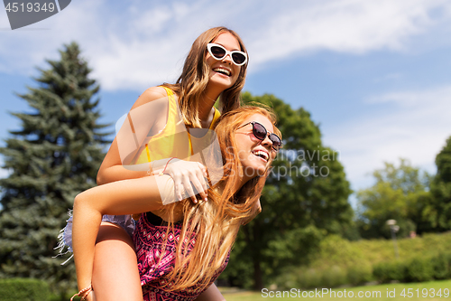 Image of happy teenage girls having fun at summer park