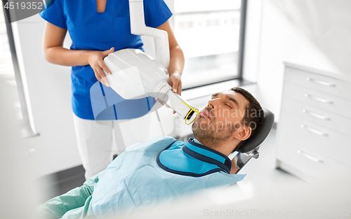 Image of dentist making dental x-ray of patient teeth