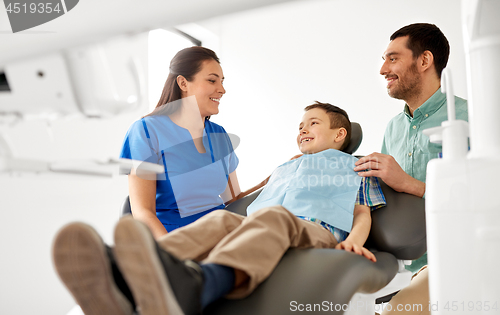 Image of female dentist with kid patient at dental clinic