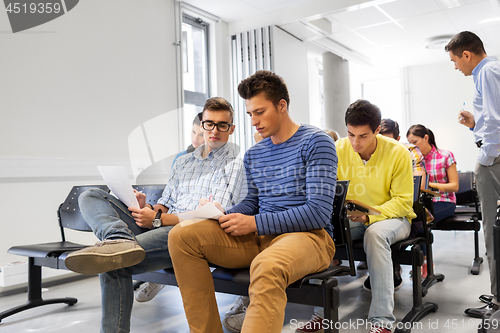 Image of group of students with papers in lecture hall