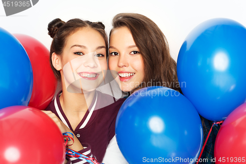 Image of happy teenage girls with helium balloons