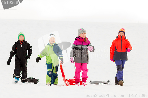 Image of happy little kids with sleds in winter