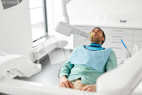 Image of patient having x-ray scanning at dental clinic