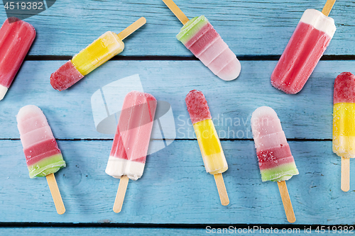 Image of Ice cream stick placed on a blue vintage wooden 