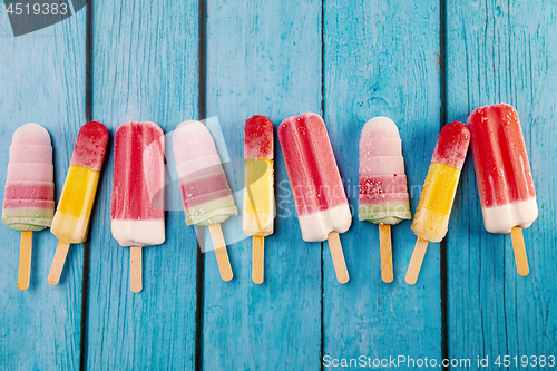 Image of Ice cream stick placed on a blue vintage wooden 