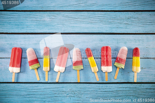 Image of Ice cream stick placed on a blue vintage wooden 