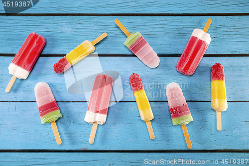 Image of Ice cream stick placed on a blue vintage wooden 