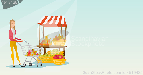 Image of Young caucasian woman pushing a supermarket cart.