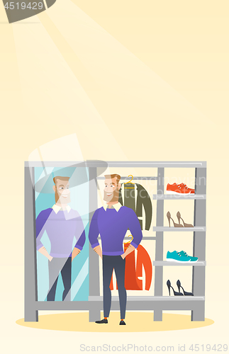 Image of Caucasian man trying on sweater in a dressing room