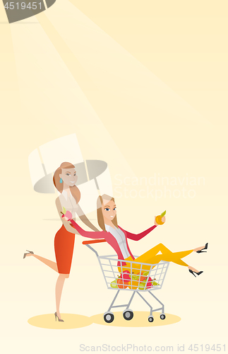 Image of Couple of friends riding in shopping trolley.