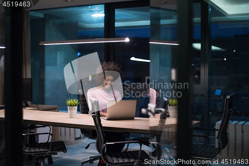 Image of black businesswoman using a laptop in startup office