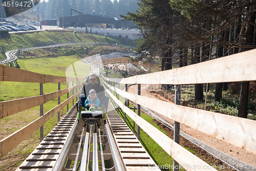 Image of father and son enjoys driving on alpine coaster