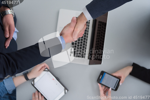 Image of cloasing the deal in modern office interior top view