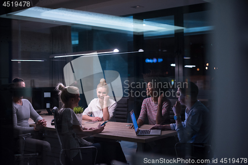 Image of Multiethnic startup business team in night office