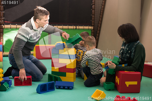 Image of parents having fun with kids