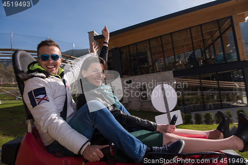 Image of couple enjoys driving on alpine coaster