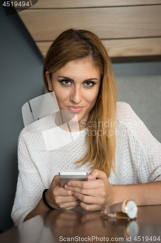 Image of young woman using mobile phone