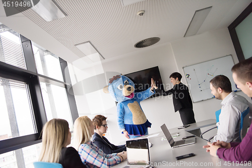 Image of boss dresed as bear having fun with business people in trendy of