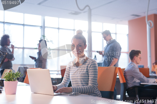 Image of businesswoman using a laptop in startup office