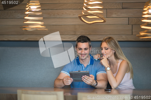 Image of couple using tablet at home