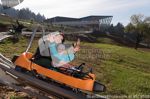 Image of mother and son enjoys driving on alpine coaster