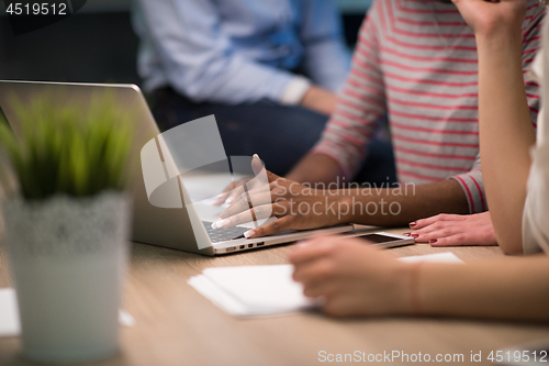 Image of Multiethnic startup business team in night office