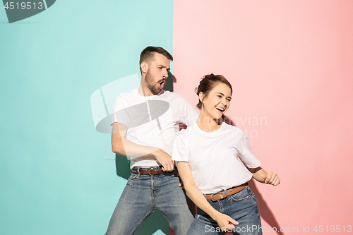 Image of A couple of young man and woman dancing hip-hop at studio.