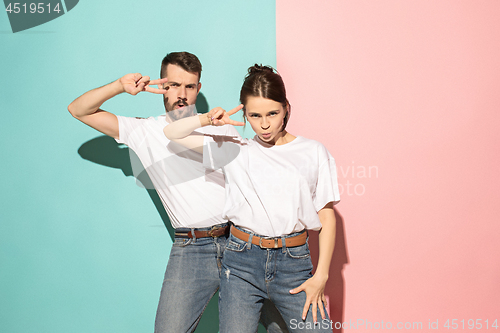 Image of A couple of young man and woman dancing hip-hop at studio.