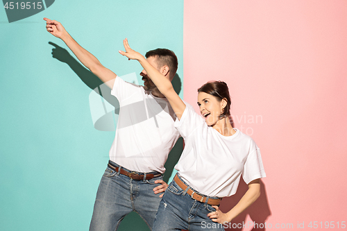 Image of A couple of young man and woman dancing hip-hop at studio.