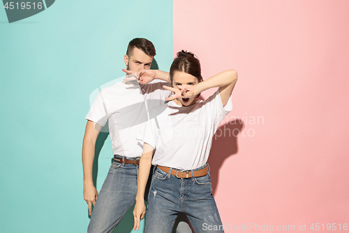 Image of A couple of young man and woman dancing hip-hop at studio.