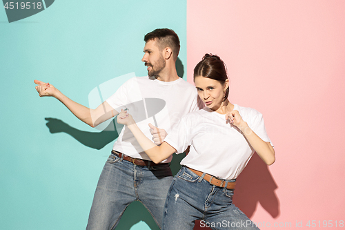 Image of A couple of young man and woman dancing hip-hop at studio.