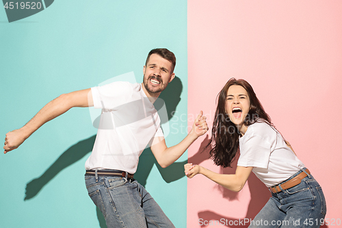 Image of A couple of young man and woman dancing hip-hop at studio.