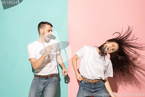 Image of A couple of young man and woman dancing hip-hop at studio.