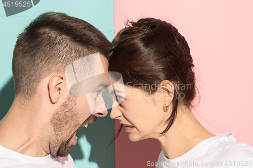 Image of attractive angry couple fighting and shouting at each other