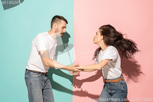 Image of A couple of young man and woman dancing hip-hop at studio.