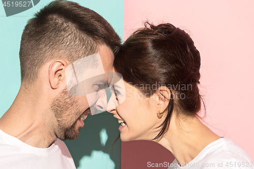 Image of attractive angry couple fighting and shouting at each other