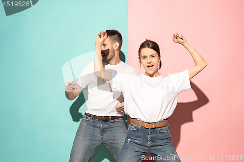 Image of A couple of young man and woman dancing hip-hop at studio.