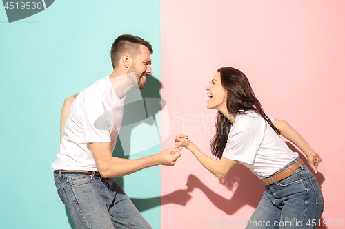 Image of A couple of young man and woman dancing hip-hop at studio.