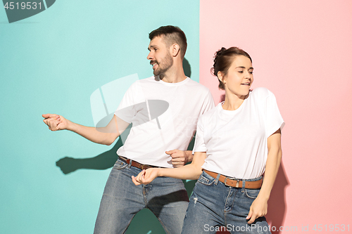 Image of A couple of young man and woman dancing hip-hop at studio.