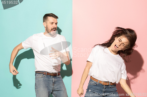 Image of A couple of young man and woman dancing hip-hop at studio.