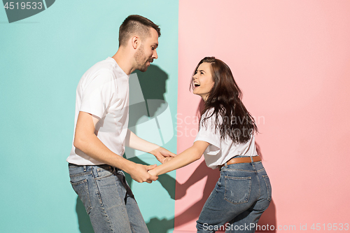 Image of A couple of young man and woman dancing hip-hop at studio.