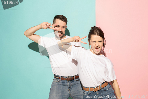 Image of A couple of young man and woman dancing hip-hop at studio.